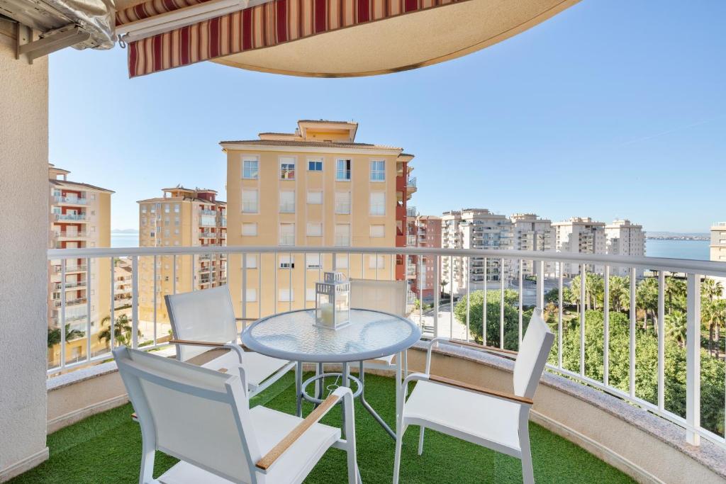 a balcony with a table and chairs and a view at Mistral Apartment La Manga in San Javier