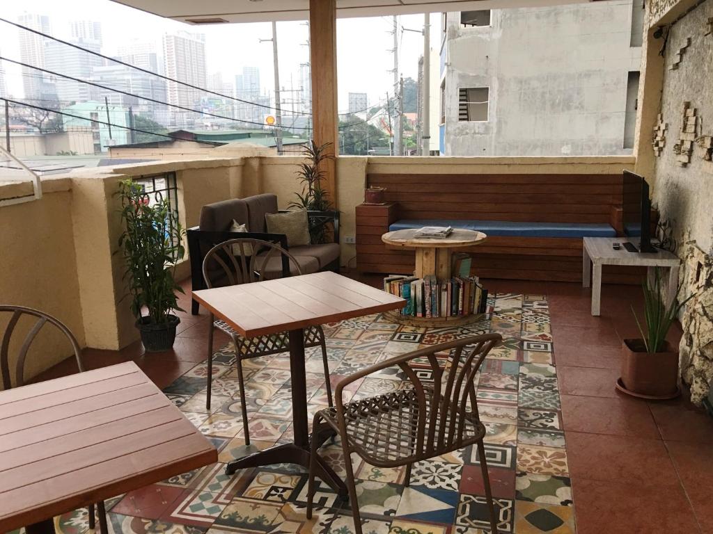 a restaurant with tables and chairs in a room at 1 River Central Hostel in Manila
