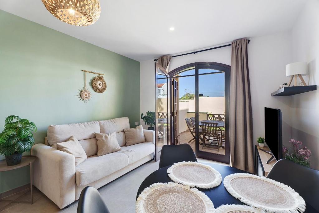 a living room with a couch and a table at Casa Tagoro Dream in Costa Del Silencio