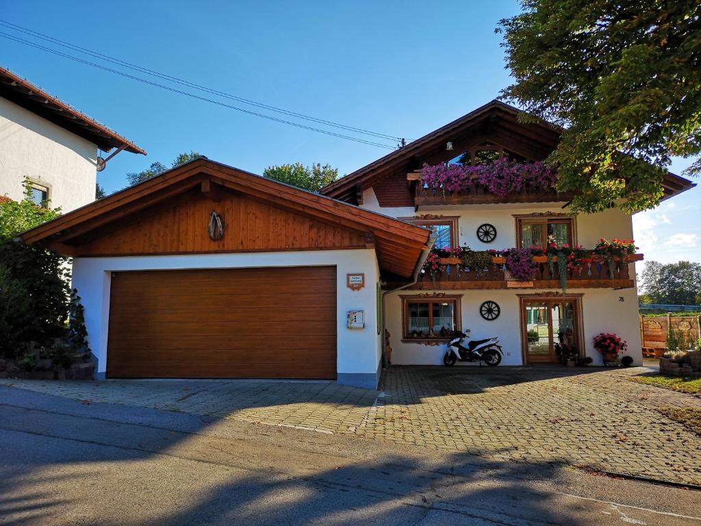 a house with a brown garage door in front of it at Haus Elfriede Schmid in Bad Bayersoien