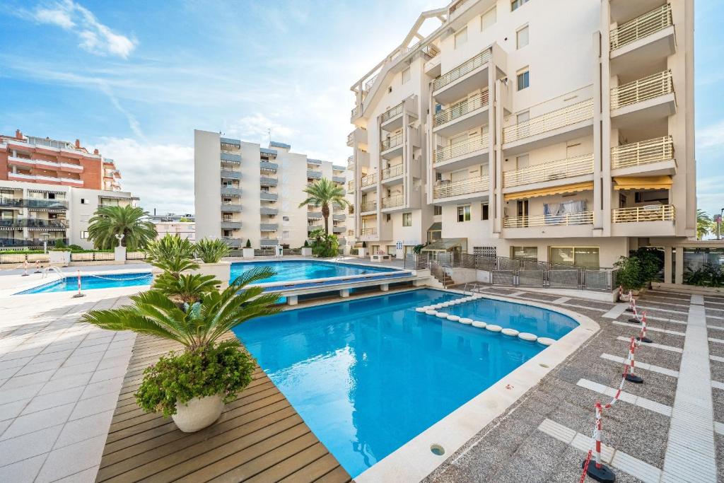 an apartment with a swimming pool in a building at Salou apartment beach in Salou