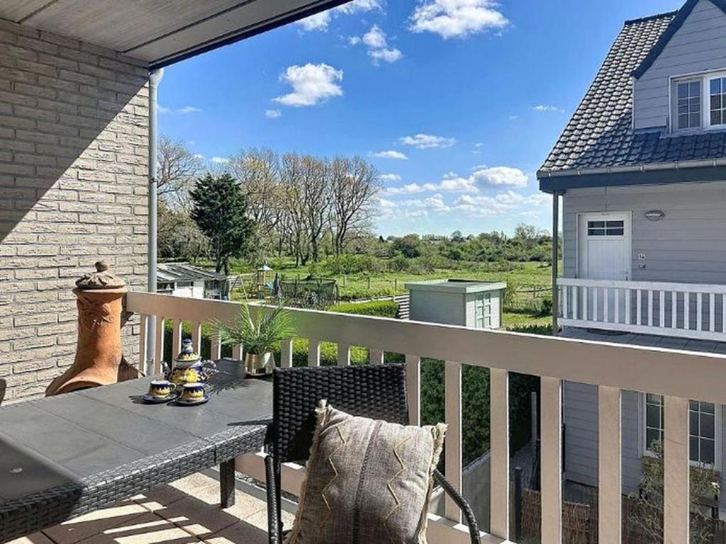 a patio with a table and chairs on a balcony at Apartment The Horseshoe with parking by Interhome in Bredene