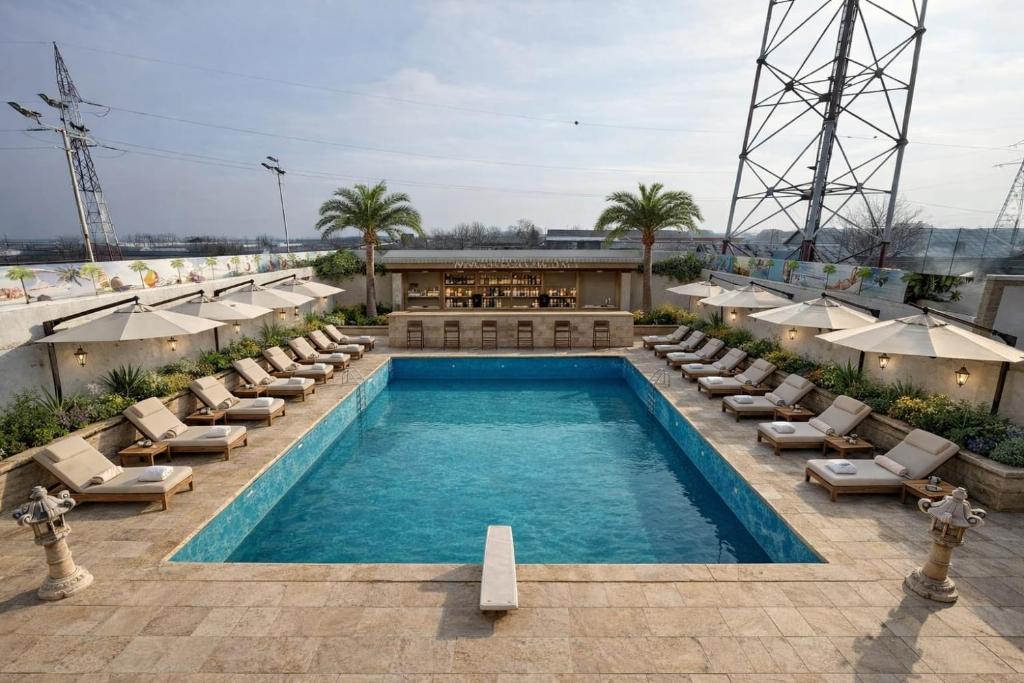 a swimming pool with lounge chairs and a hotel at Hotel Imperium & Pool in Caracal