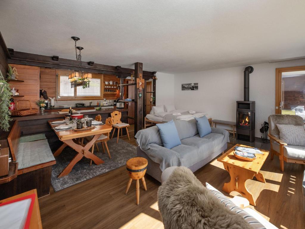a living room with a couch and a table at Apartment SnowKaya Grindelwald by Interhome in Grindelwald
