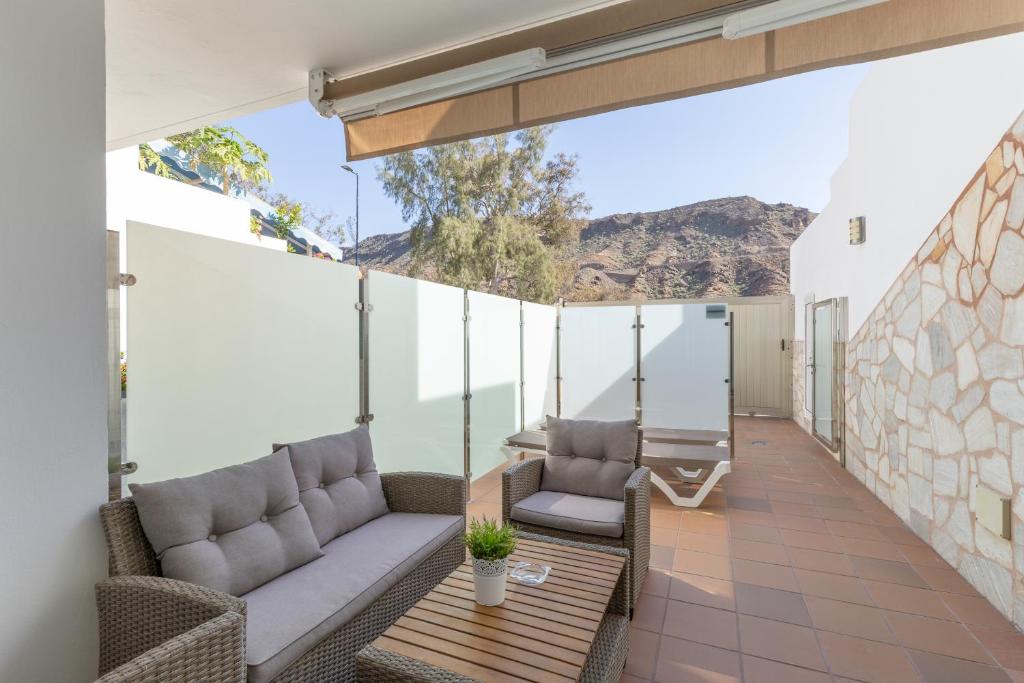 a patio with two couches and a swing at Vv Ancla in Puerto de Mogán