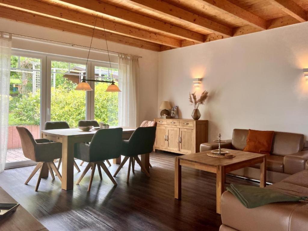 a living room with a table and chairs and a couch at Ferienhaus Marlen in Naumburg