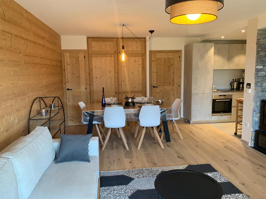 a living room with a couch and a table at Flambeaux A 12 Roca immobilier in Châtel