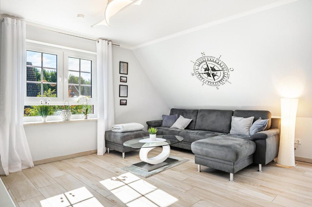 a living room with a couch and a table at Haus Ankerplatz in Wischhafen