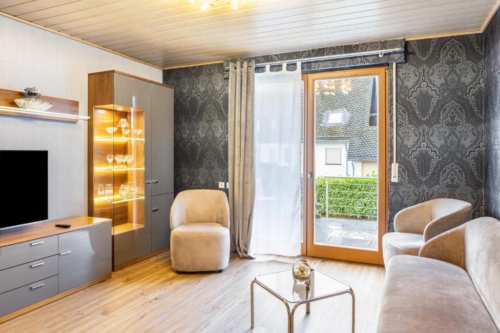 a living room with a couch and a tv at Marisa's Sauerlandträumchen in Brilon