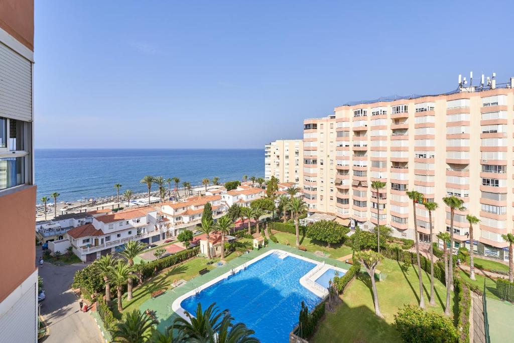an aerial view of a resort with a swimming pool and the ocean at Great views studio A84 in Torrox
