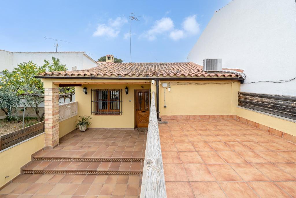 a house with a patio and a door at la casita in Las Pesas