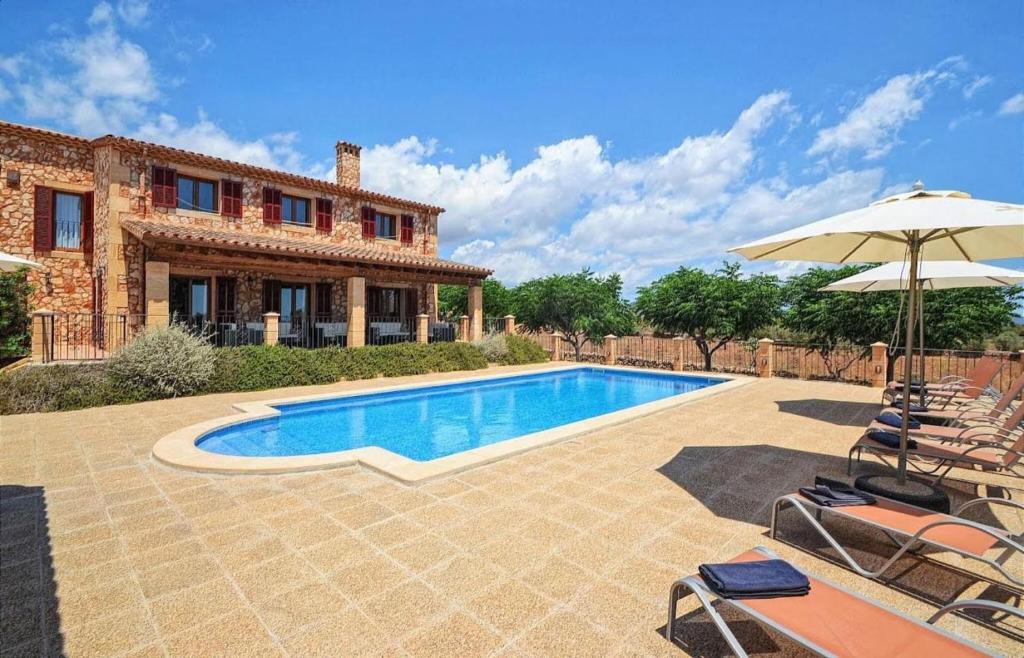 an external view of a villa with a swimming pool at Can Pedro - Sa Torre Nova in Son Carrió