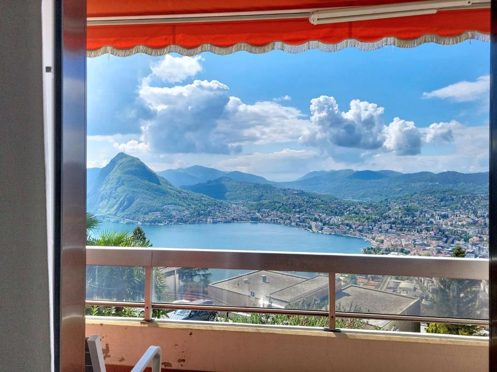 a view of a lake from a window at Apartment Superpanorama II by Interhome in Lugano