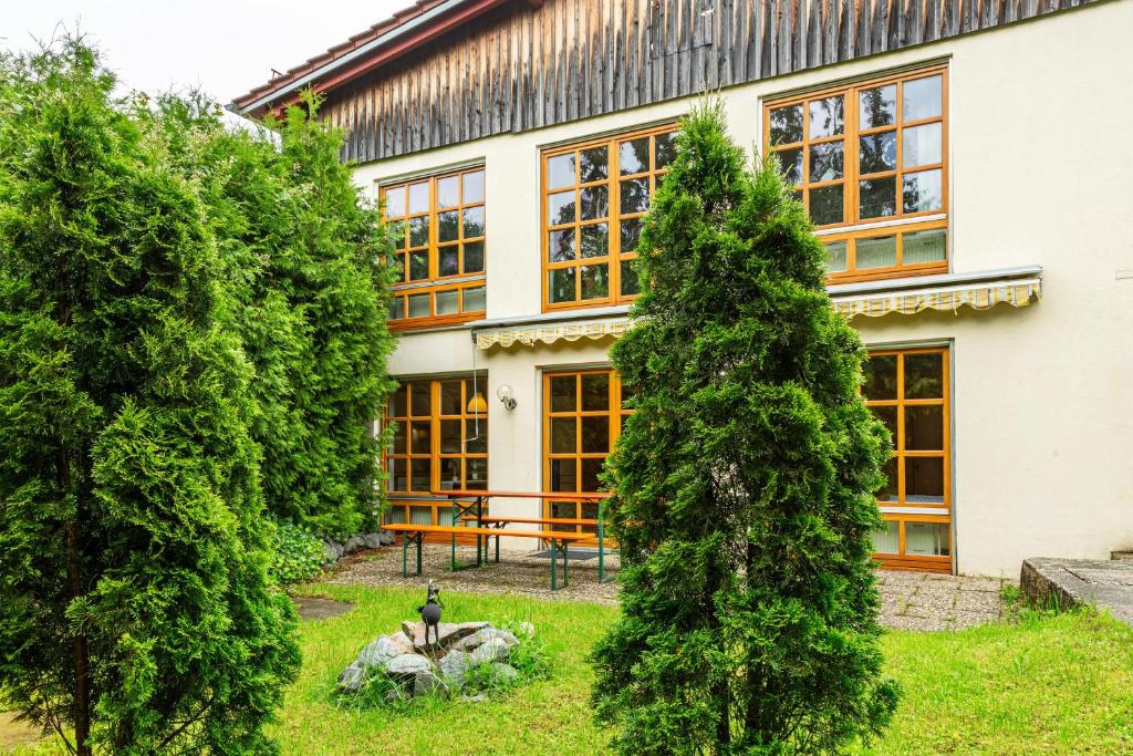 a house with trees in front of it at Ferienwohnung Schatzlmayr in Vilshofen an der Donau