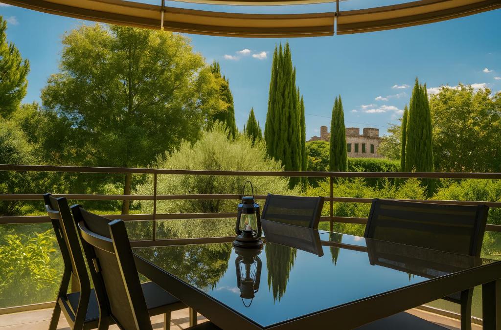 a table and chairs on a balcony with a view of trees at Appartement De Standing Avignon in Avignon