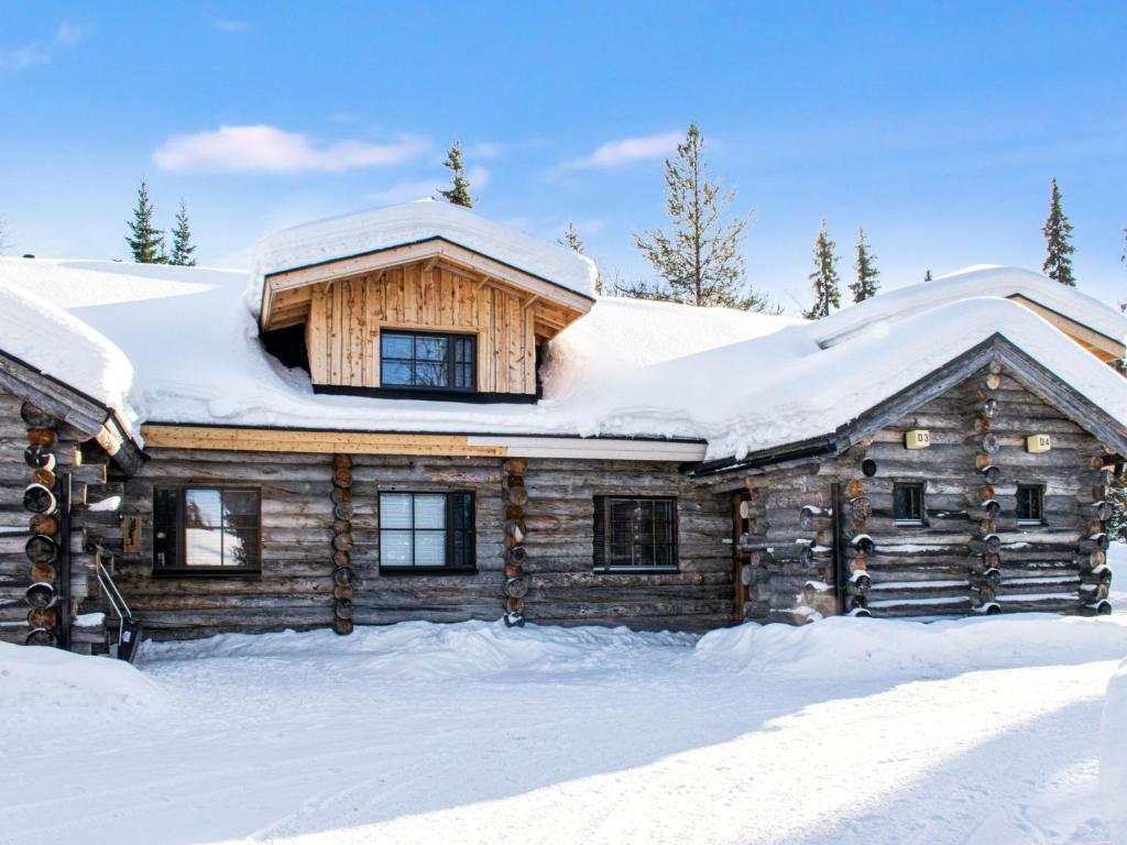 a log cabin in the snow at Holiday Home Kantapää d3 by Interhome in Luosto