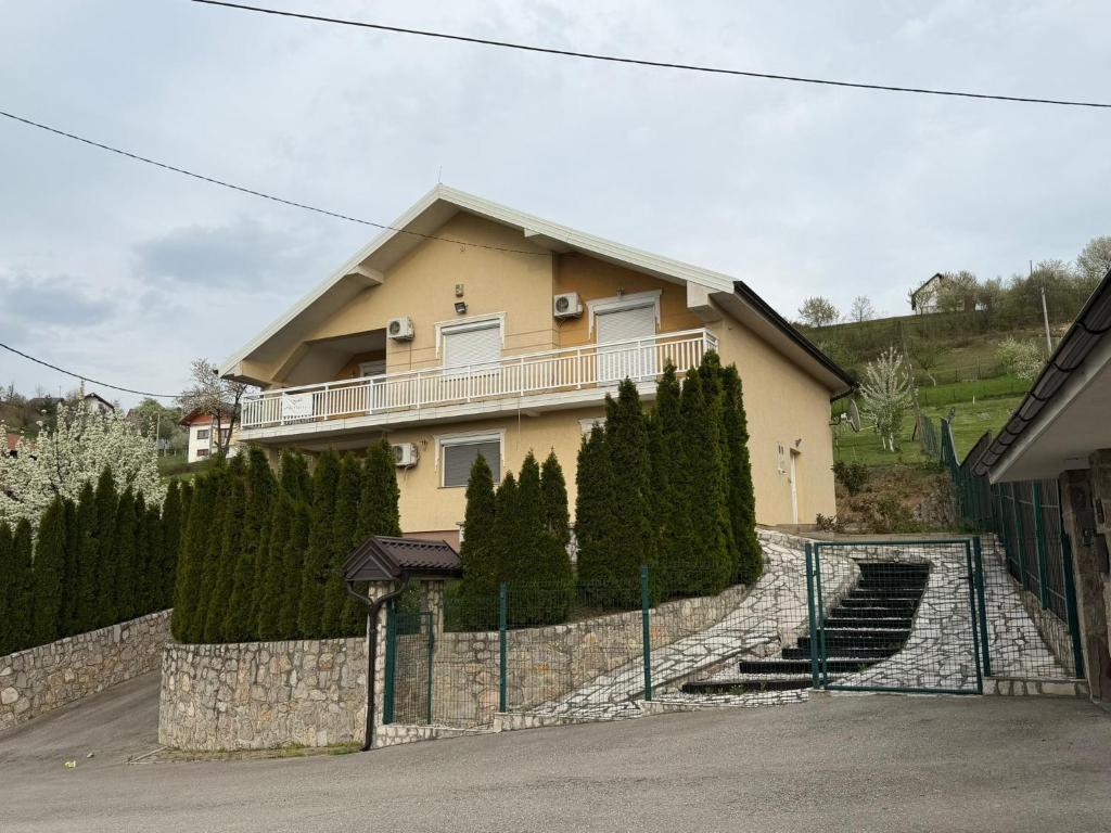 a house with a fence in front of it at Villa Rest Ilijas 4 bedrooms in Ilijaš