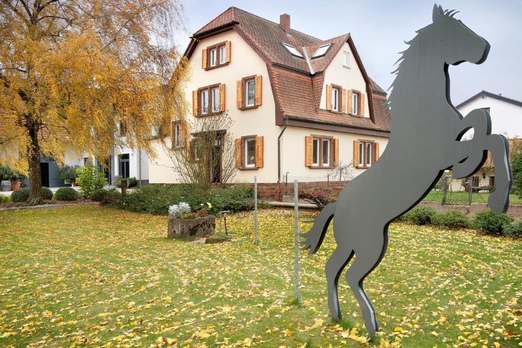 a statue of a horse in front of a house at Klostergarten in Grünstadt
