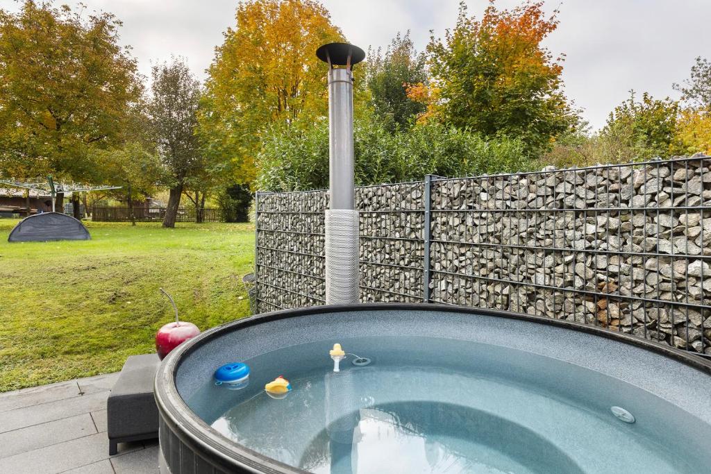 a hot tub in a backyard with a fence at Helgas Horizon in Rottweil