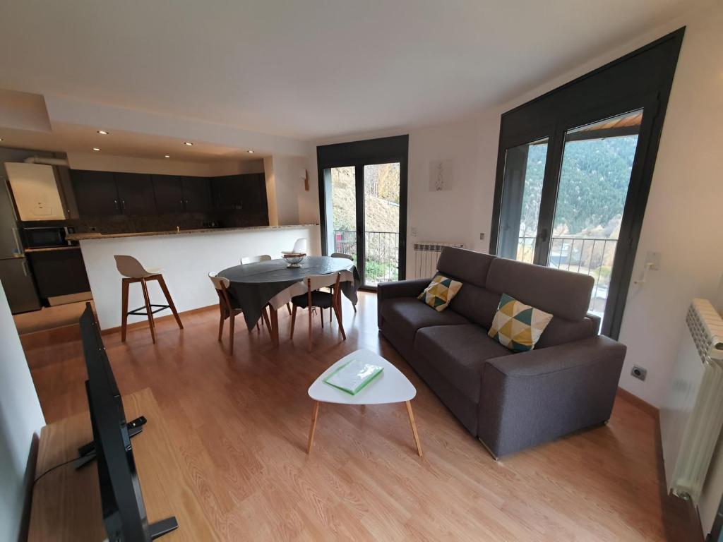 a living room with a couch and a table at Altissim Font de Ferro in Ransol