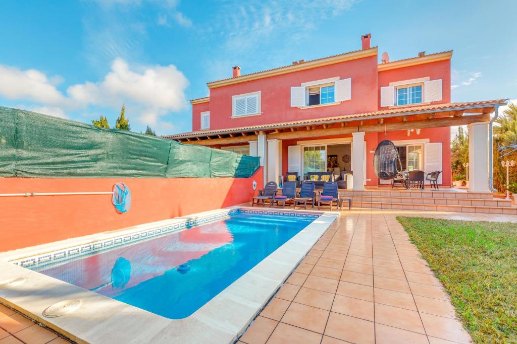 a home with a swimming pool in front of a house at Serra Fuster - Casa Tolleric in Llucmajor