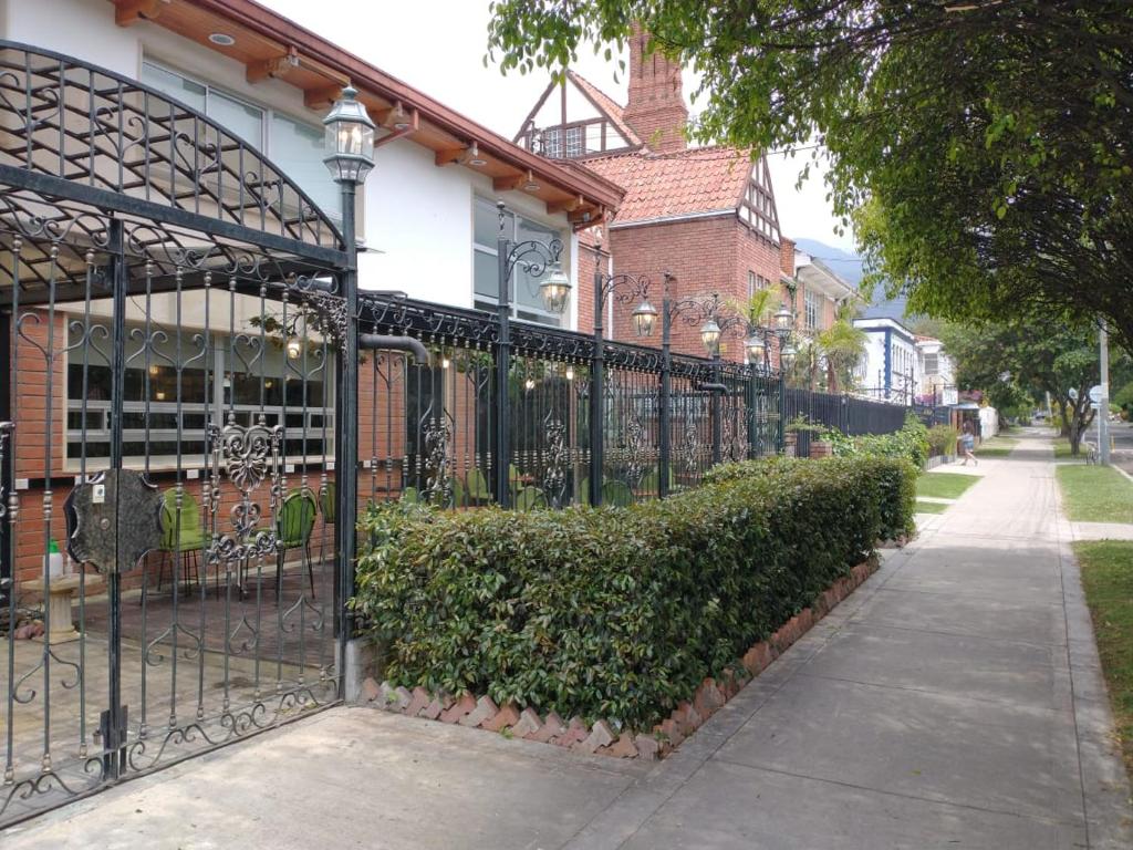 a black wrought iron fence in front of a house at Casa Lavim in Bogotá