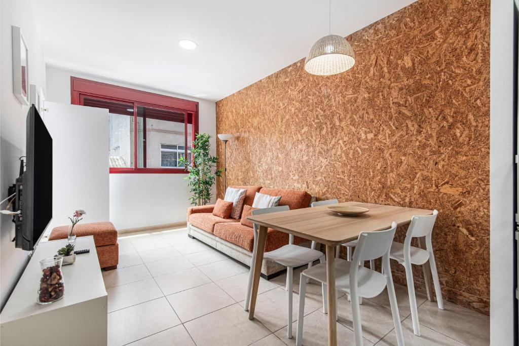 a living room with a table and a couch at Casa Almi Las Palmas in Las Palmas de Gran Canaria