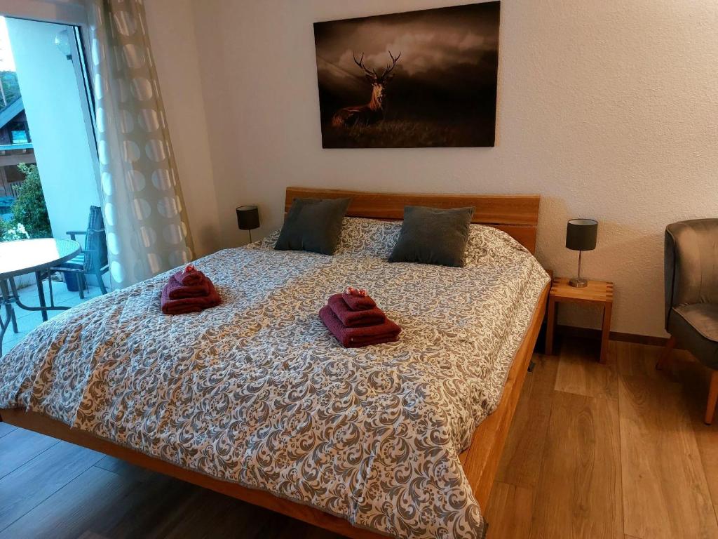 a bedroom with a bed with two red pillows on it at Ferienglück Unterkirnach in Unterkirnach