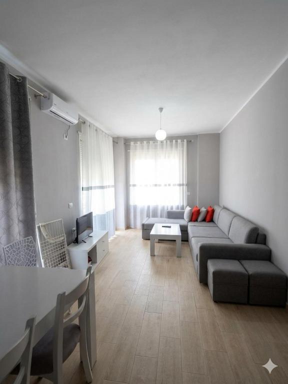 a living room with a couch and a table at Radhima Beach Apartments in Vlorë