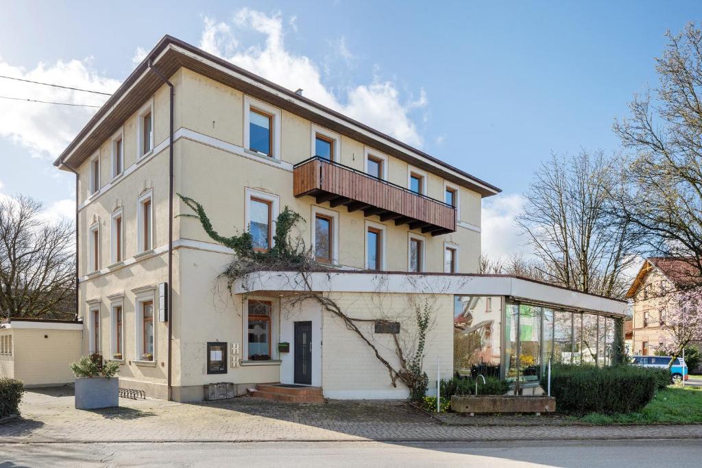 a white house with a balcony on top of it at Landhaus Trautwein in Vogtsburg
