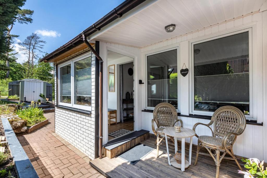 a patio with two chairs and a table at Ferienhaus Stauseeblick in Kelbra