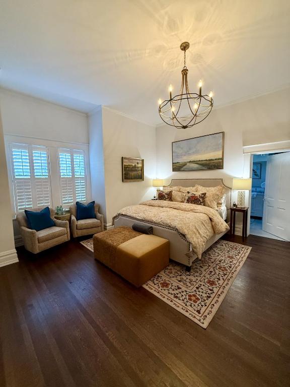 a large bedroom with a bed and a chandelier at Burrell and Flynn's Farm in Aiken