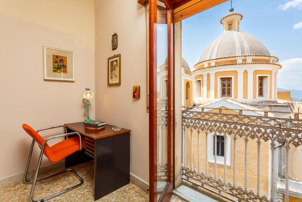 a room with a desk and a view of a building at Le Logge - Bronte in Bronte