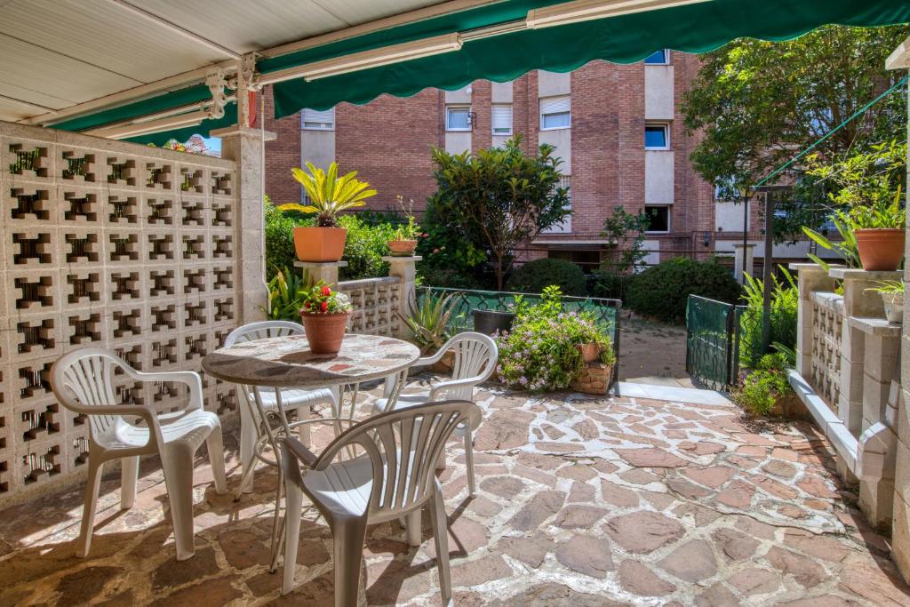a patio with a table and chairs and a fence at Nice apartment with terrace in Lloret de Mar