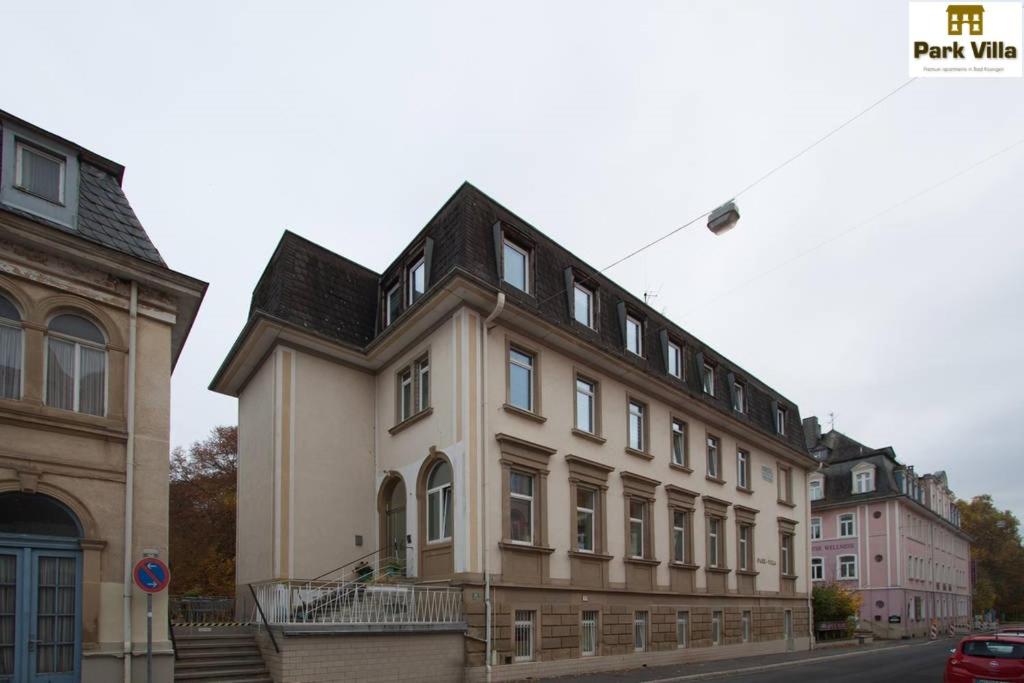 a large white building with a black roof at Park Villa Apartments in Bad Kissingen