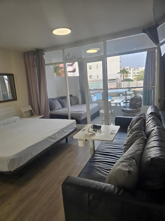 a living room with a bed and a couch at Apartamento Yumbo Roque Nublo in San Bartolomé