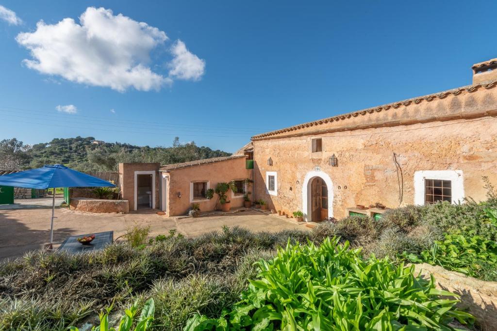 an old building with an umbrella in front of it at Can Bonjesus in Felanitx