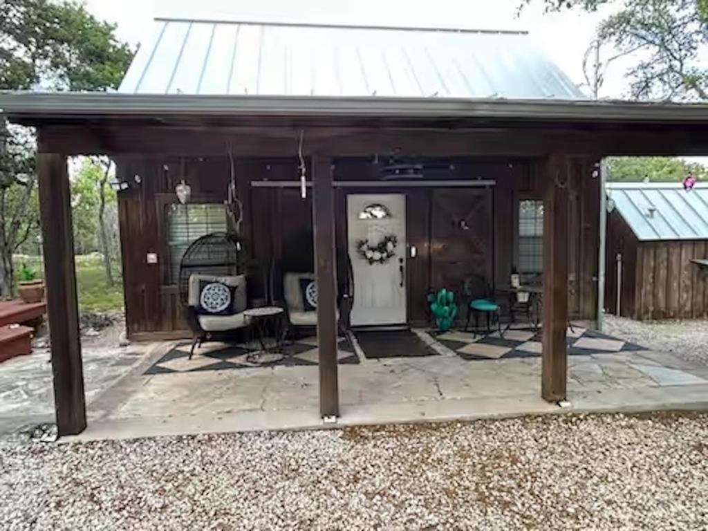 a pavilion with a table and chairs in a yard at Prickly Pear - Rustic Cabin in New Braunfels