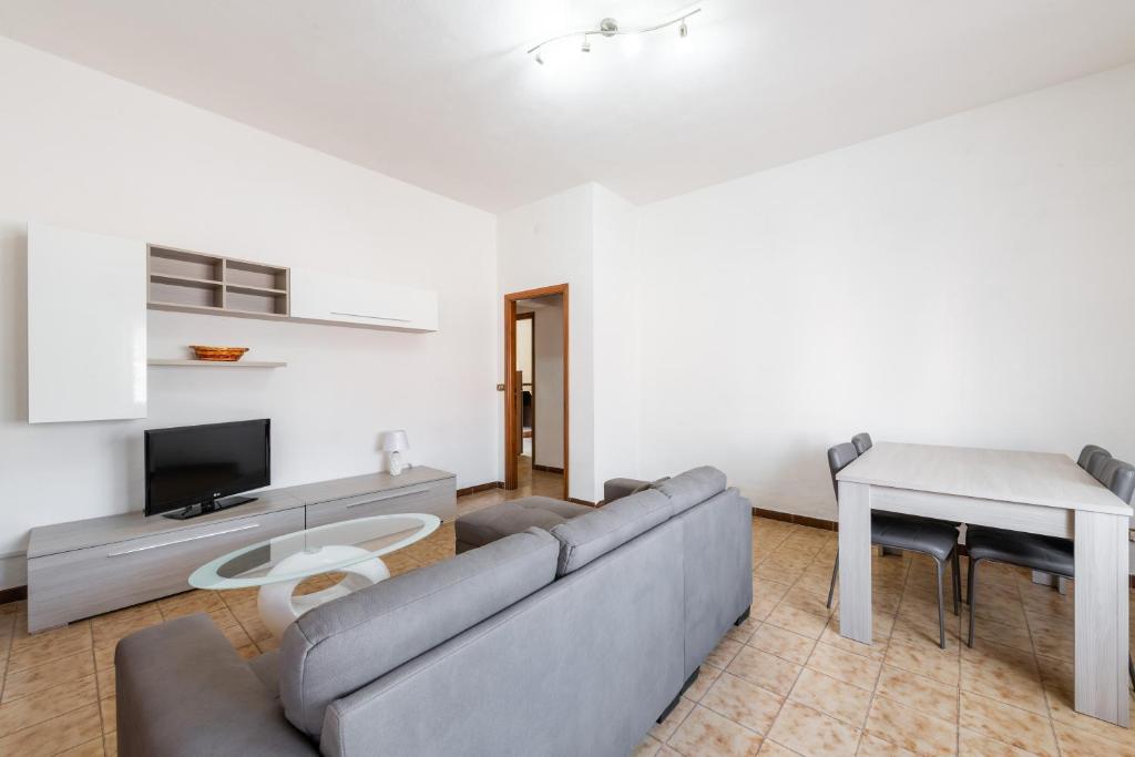 a living room with a couch and a table at Casa Vacanze Teulada in Teulada