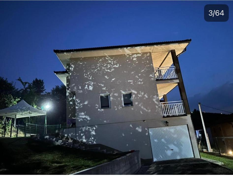 a white building with aventh floor at night at Villa Ilijas 3 bedrooms in Ilijaš
