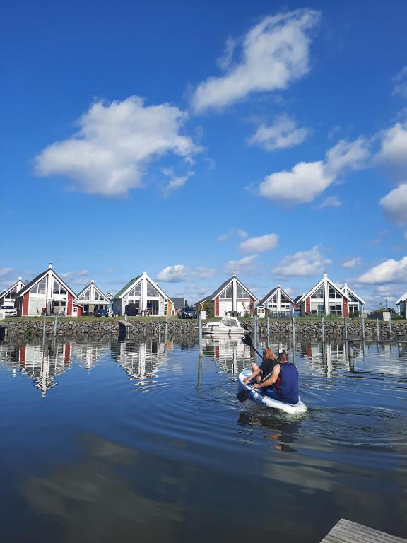 two people in a paddle boat on a body of water at Haus Abendsonne in Wandlitz