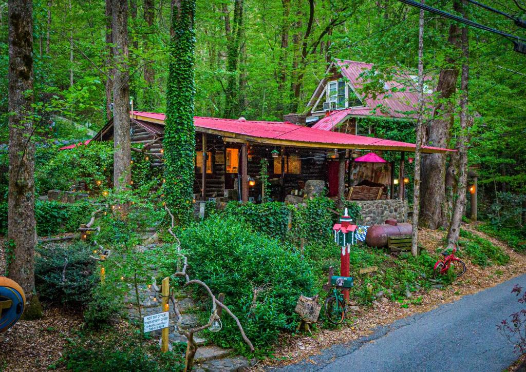a house with a red roof in the woods at Log Cabin in Helen