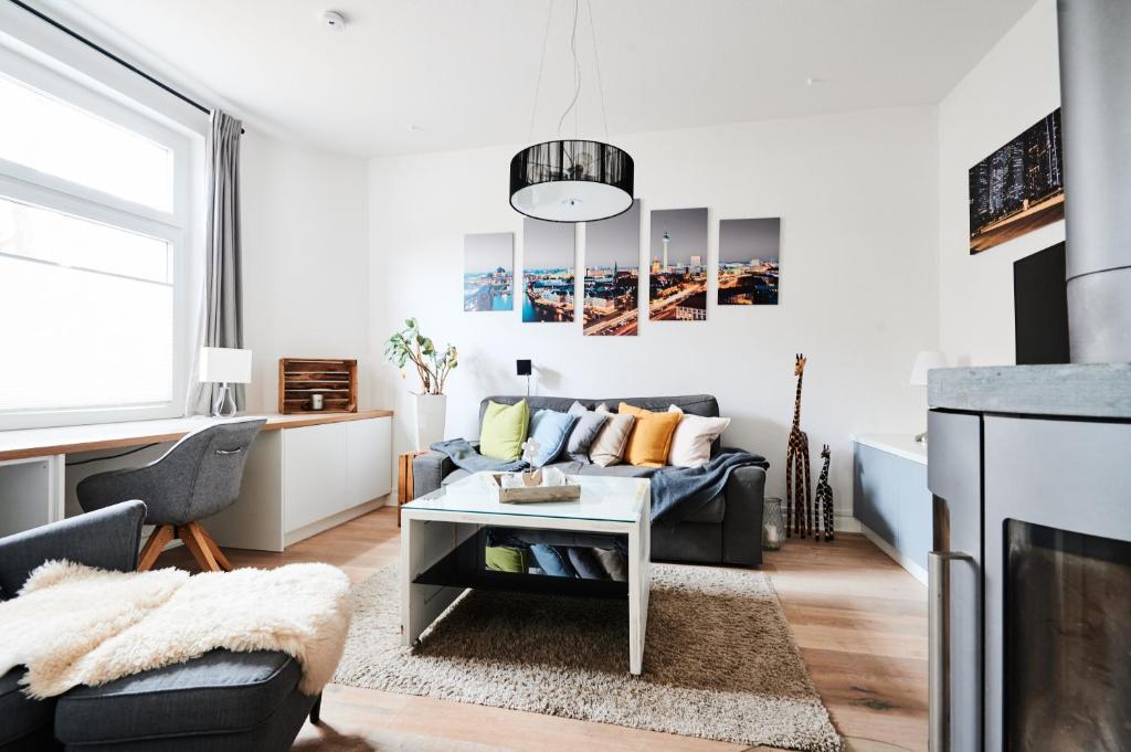 a living room with a couch and a table at Einzigartige Tischlerwohnung in Oldenburg