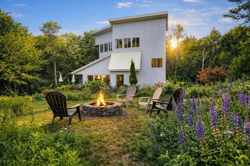 a fire pit in the yard of a house at Modern Glass House with Firepit, Views & Private Retreat in Elka Park
