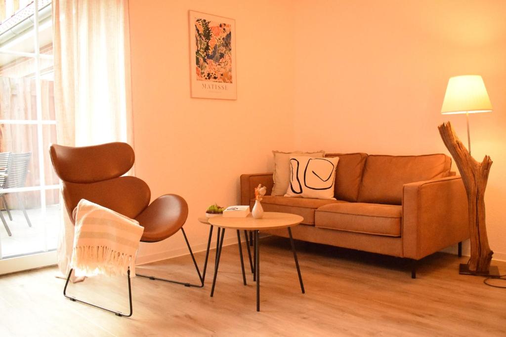 a living room with a couch and a table at Fewo Tenne in Menslage