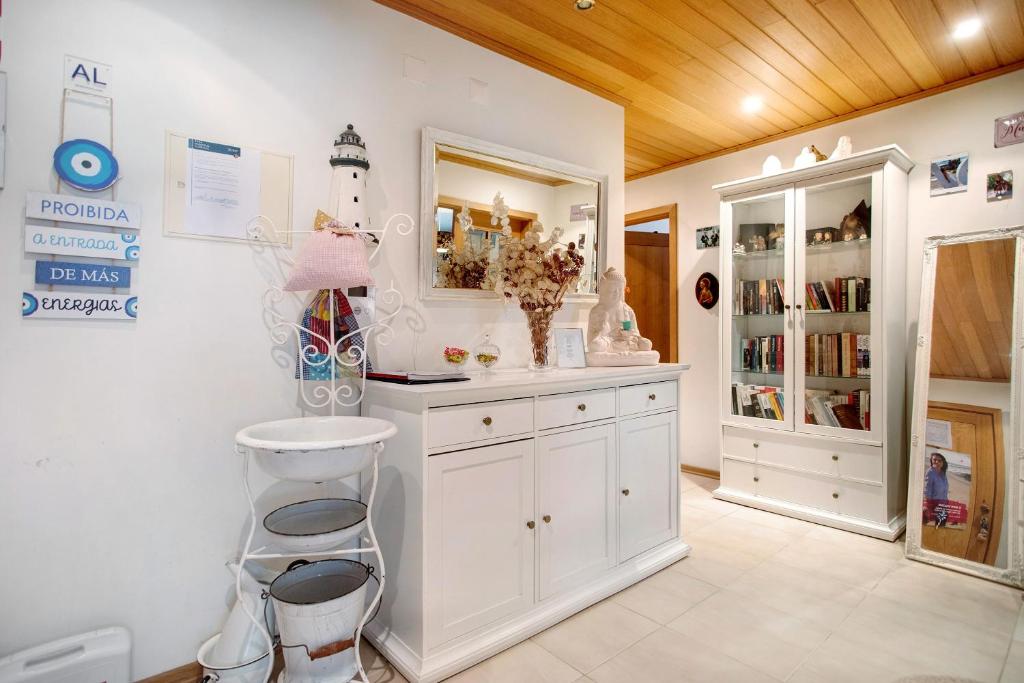 a bathroom with a white vanity and a mirror at Casa da Mãe Maria in Buarcos