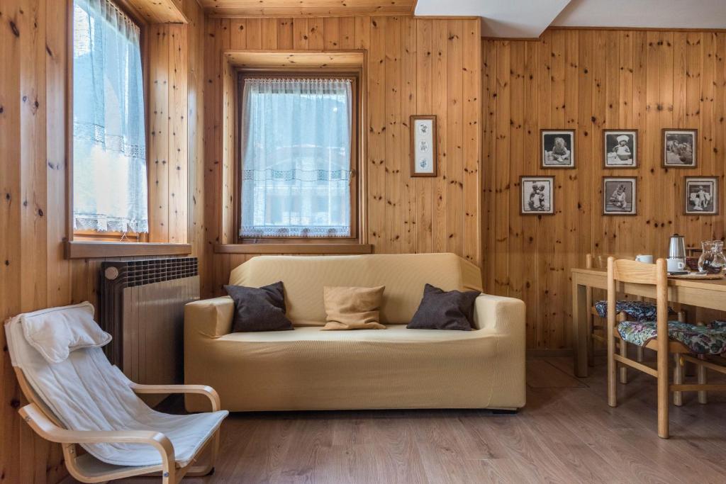a living room with a couch and a table at Appartamento Adamello Casa Lucia in Pinzolo