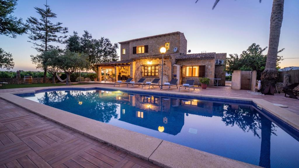 a house with a swimming pool in front of a house at Vinyes Can Grau in Sencelles