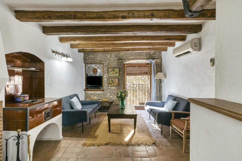 a living room with couches and a table at Can Roca in Montiró
