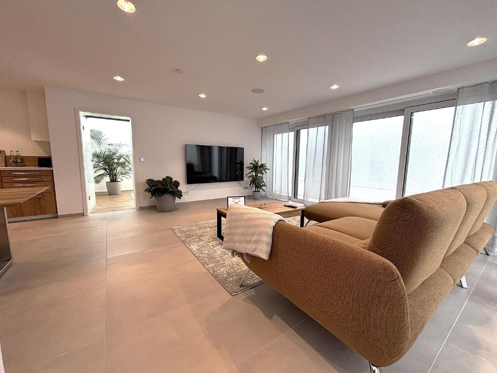 a living room with two chairs and a television at DonauDeluxe in Geisingen